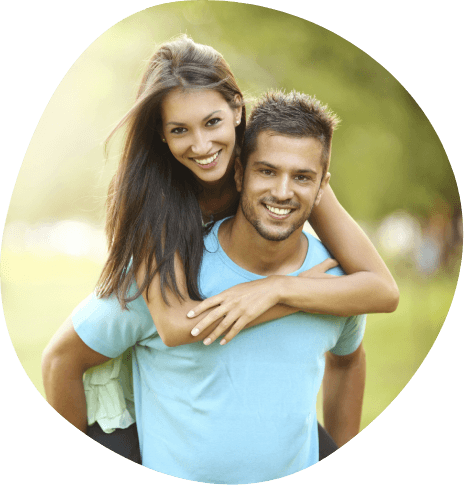 Man giving woman piggyback ride outdoors