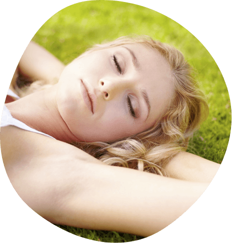 Relaxed woman laying in grass outdoors