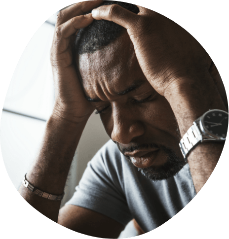 Man touching his temples in frustration