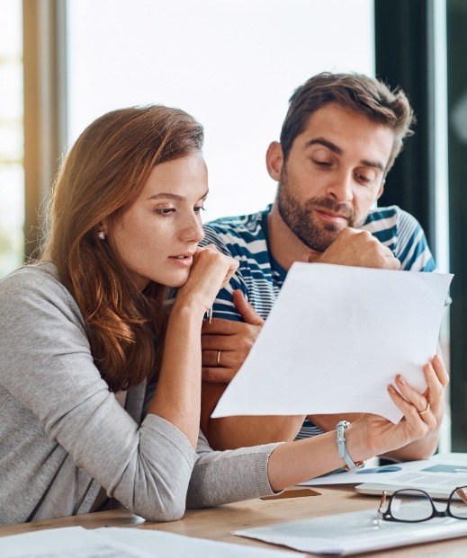 Man and woman looking at form for insurance for sleep apnea and sleep disorder treatment in Denton