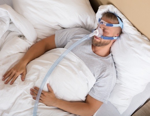 Sleeping man with C P A P mask over his face