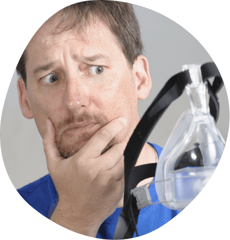 Concerned man looking at C P A P machine