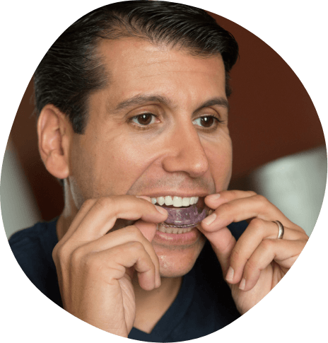 Man placing an oral appliance into his mouth