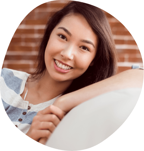 Smiling young woman sitting on couch