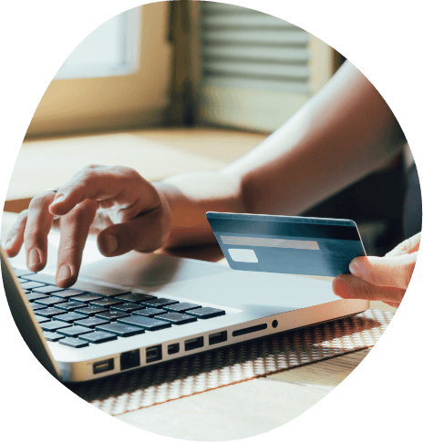 Person entering credit card information on laptop