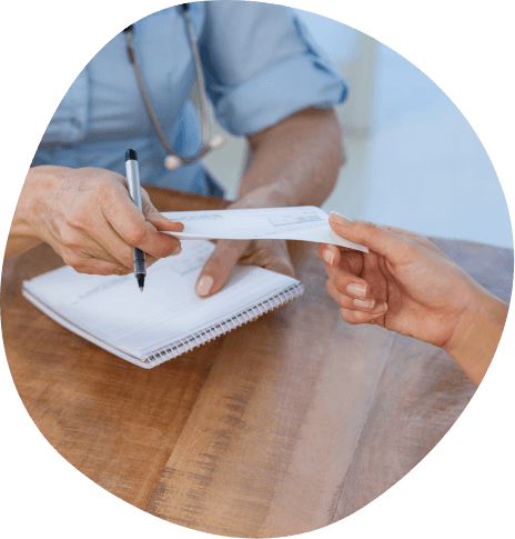 Doctor handing slip of paper to a patient