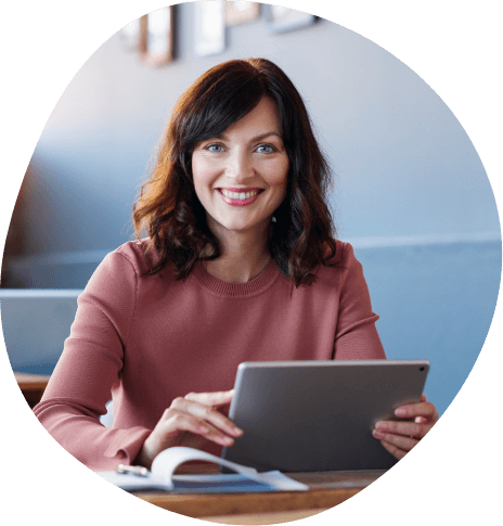 Smiling woman sitting at booth in restaurant