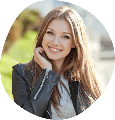 Young woman in black leather jacket smiling outdoors