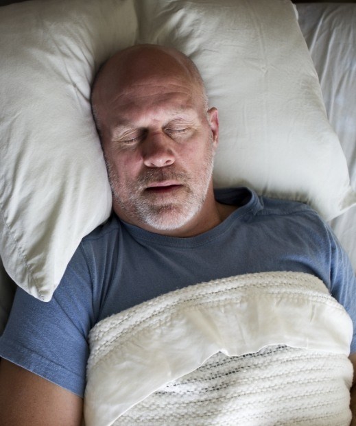 Man sleeping with mouth open before snoring treatment in Denton