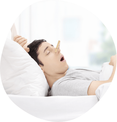 Man sleeping on his back with mouth open and clothespin over his nose