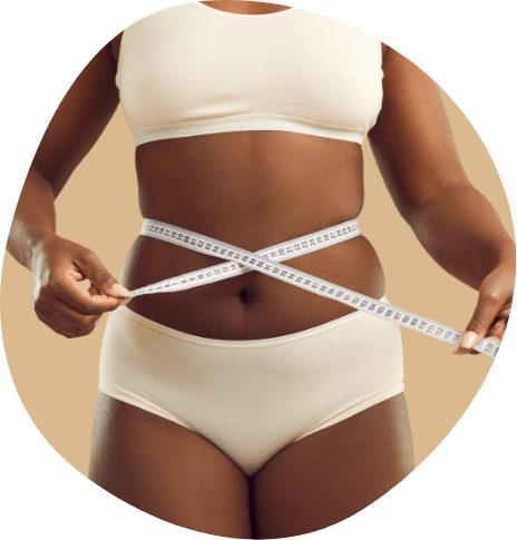 Person wrapping tape measure around their torso