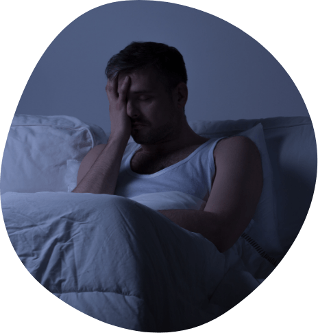 Frustrated man sitting awake in bed