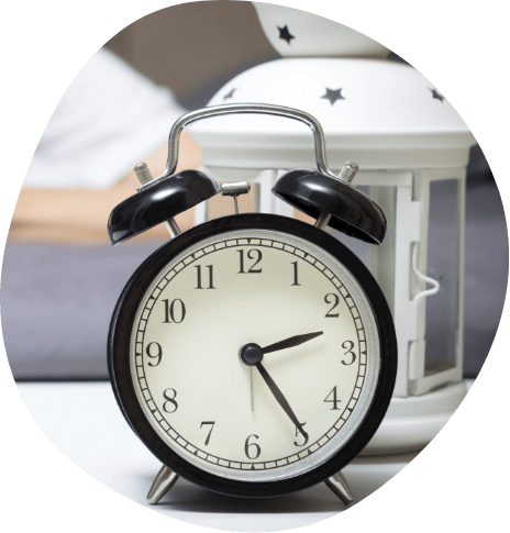 Alarm clock on bedside table showing the time as 2 25