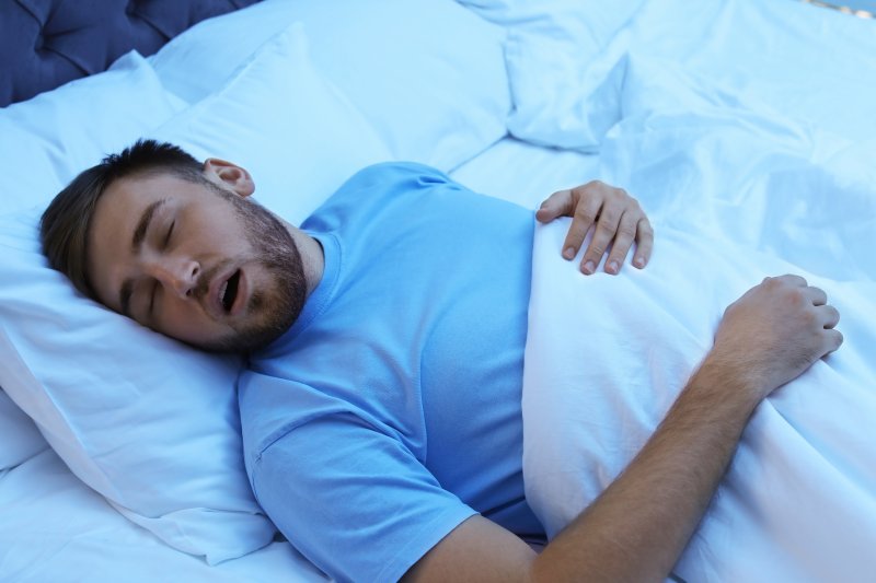 A snoring man suffering from sleep apnea