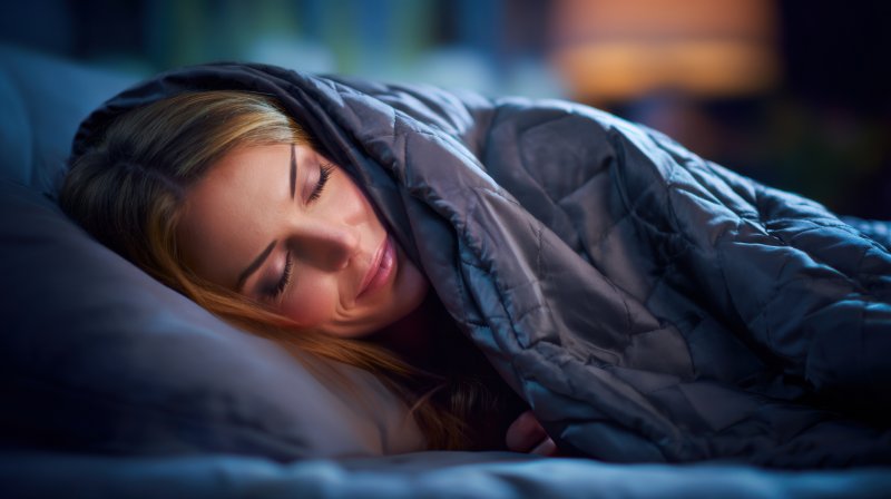 woman asleep with a weighted blanket